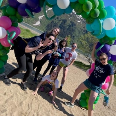 Heart & Sole team posing in front of balloon arch.